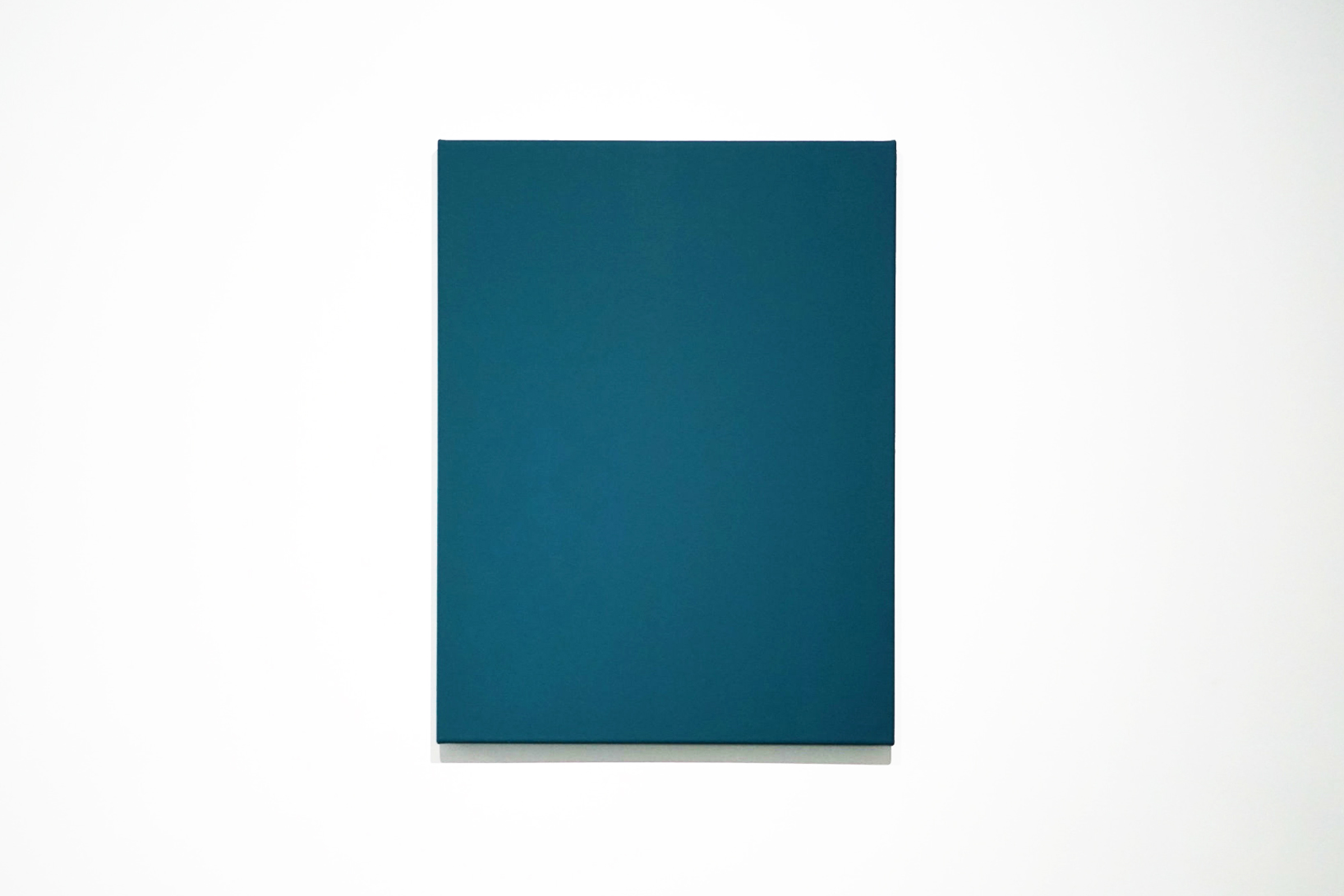 blue monochrome painting on a wall