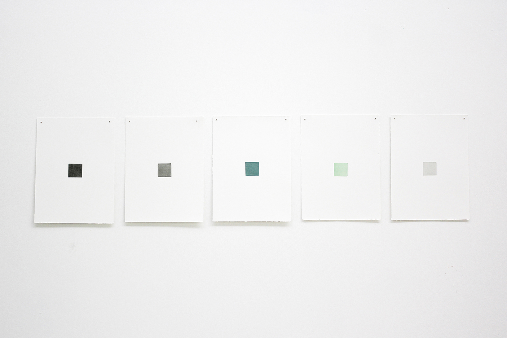 five monochrome engravings shown on a wall