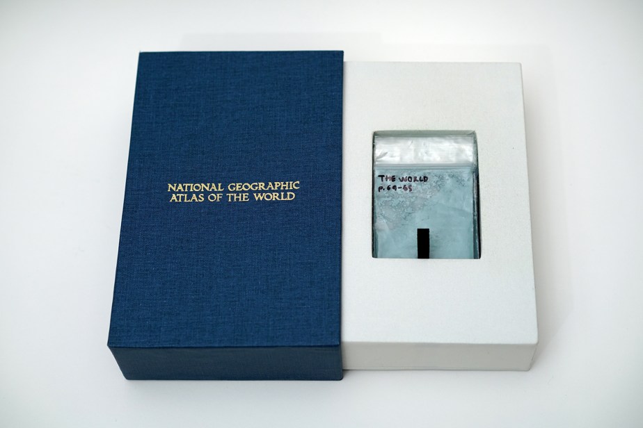 book slipcase embossed with national geographic atlas of the world containing sachets of pigments