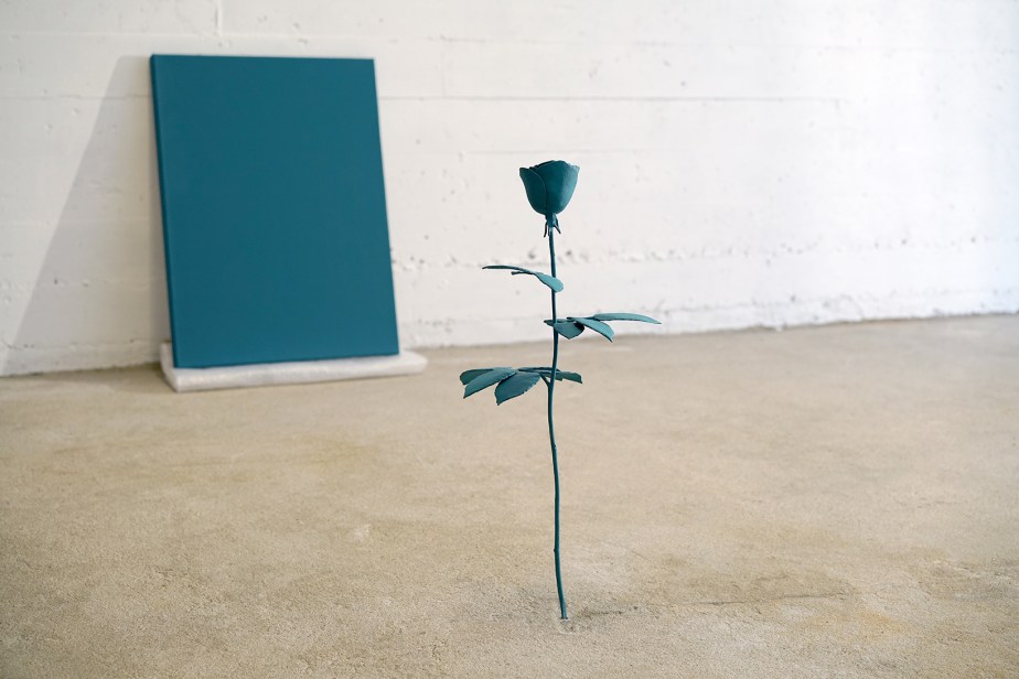 bronze casting of a rose painted with blue pigments