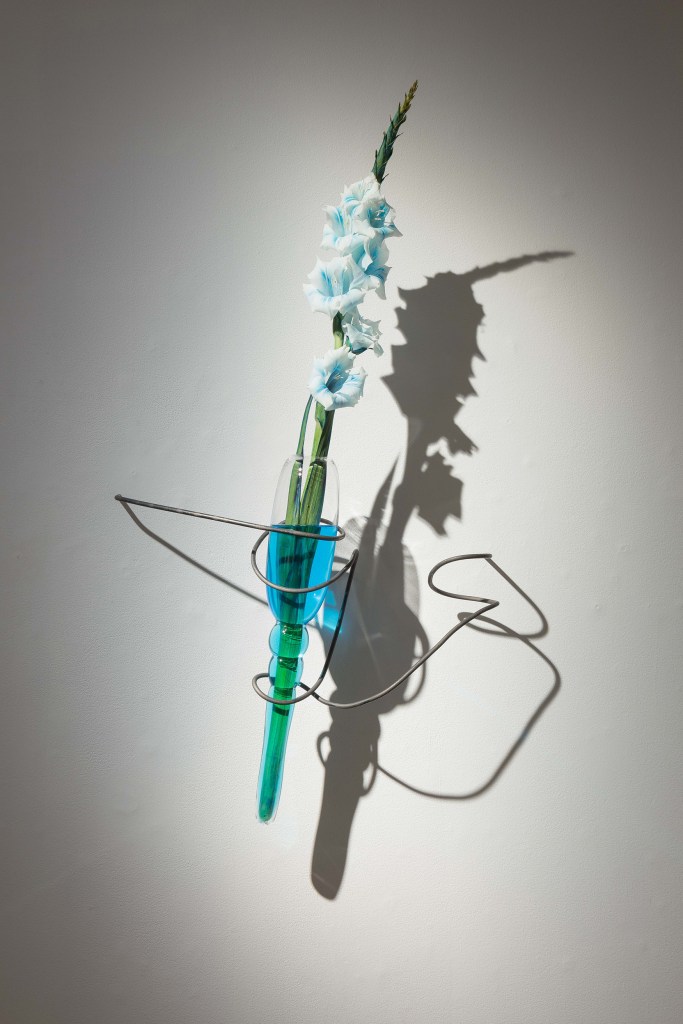 blown glass sculptures with flower and blue pigment