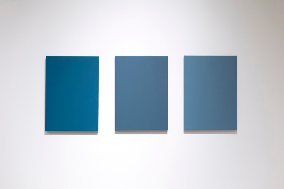 three blue monochrome paintings