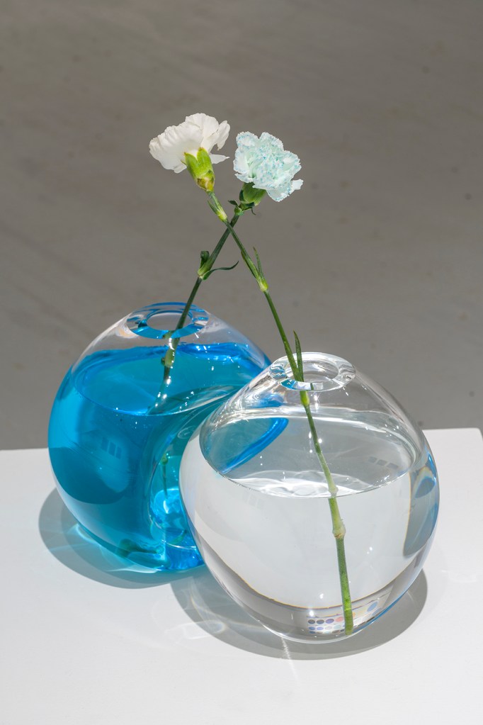 blown glass sculpture with flowers and blue pigments