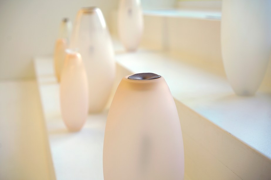 Blown glass vase with bronze sculpture of a navel